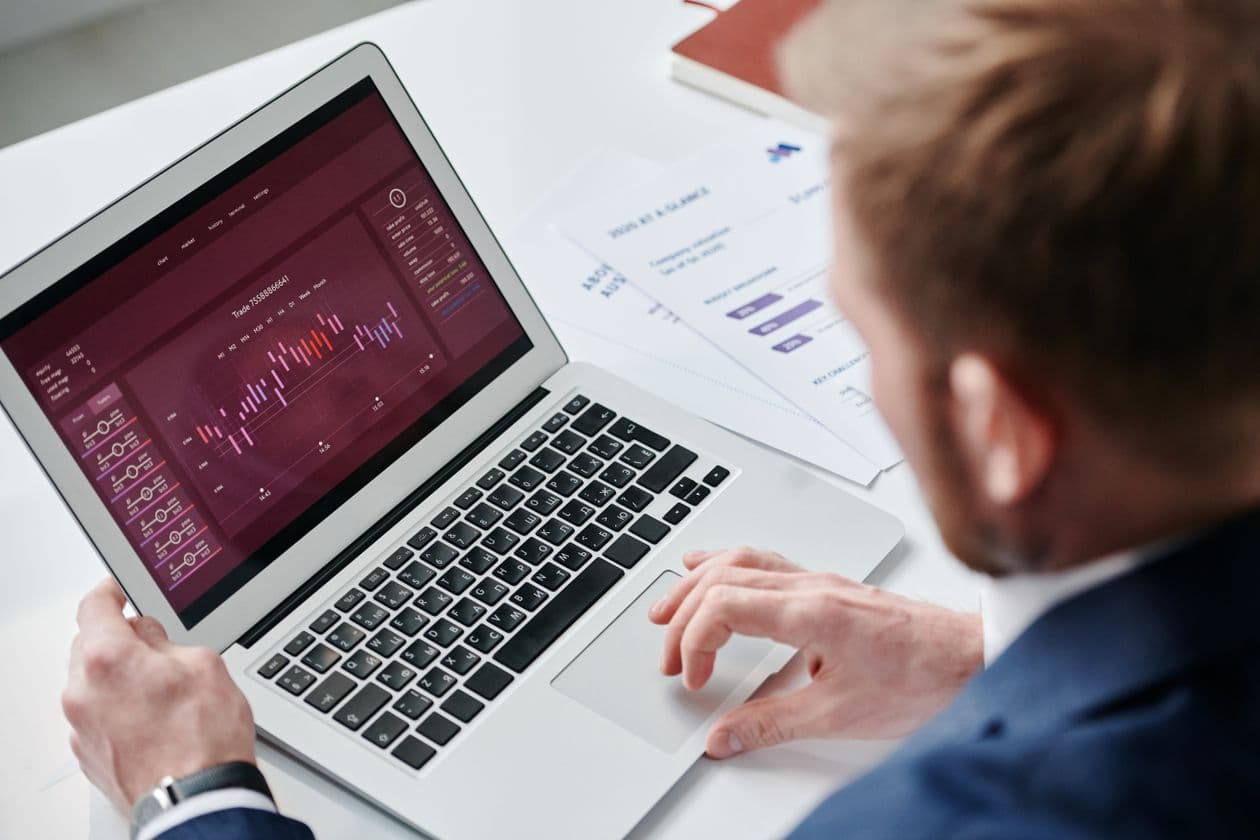Businessman reviewing a data dashboard on a laptop