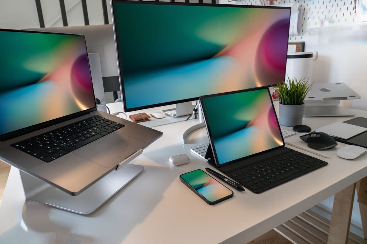 Laptop, desktop monitor, tablet and smartphone on one desk showing the same screen