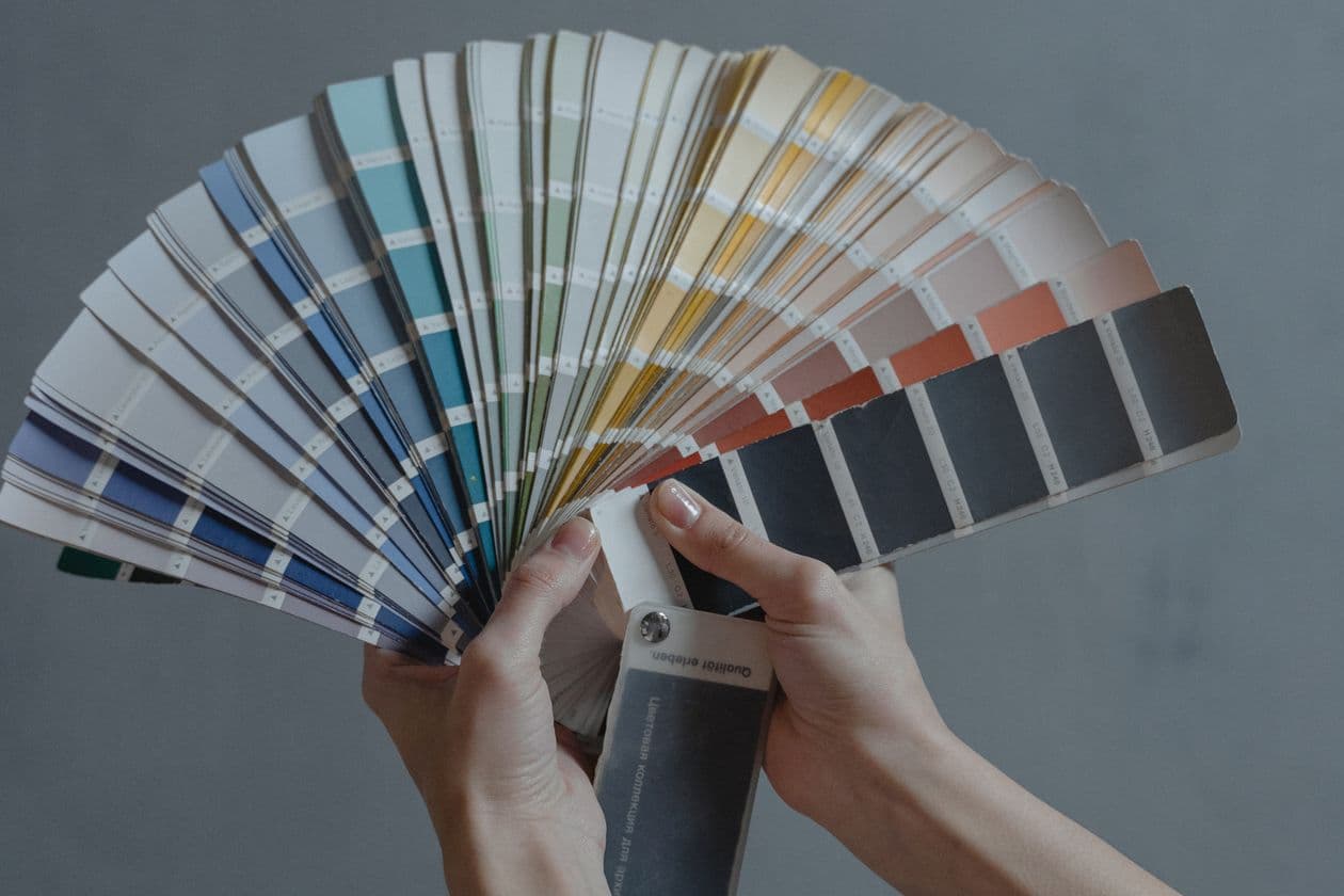 Hands fanning out a set of colour swatches