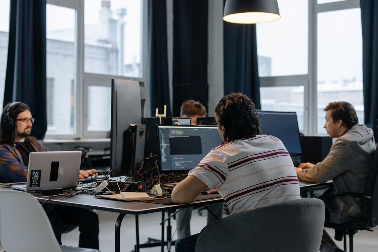 Software developers working together at computers in an office