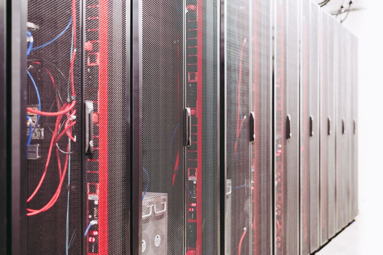 Rows of server racks with network cabling in a data centre