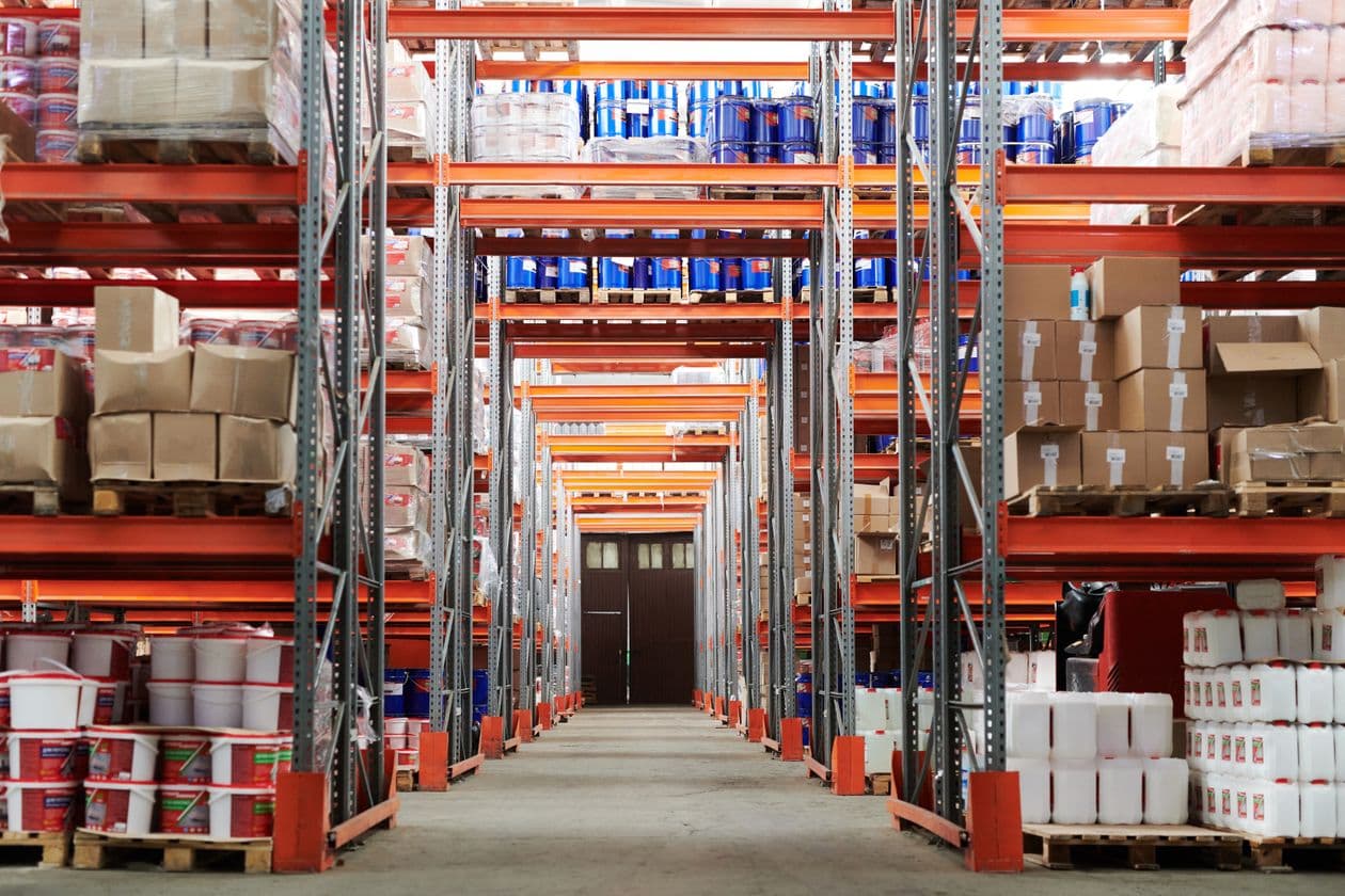 Long warehouse aisle with racks of stacked boxes